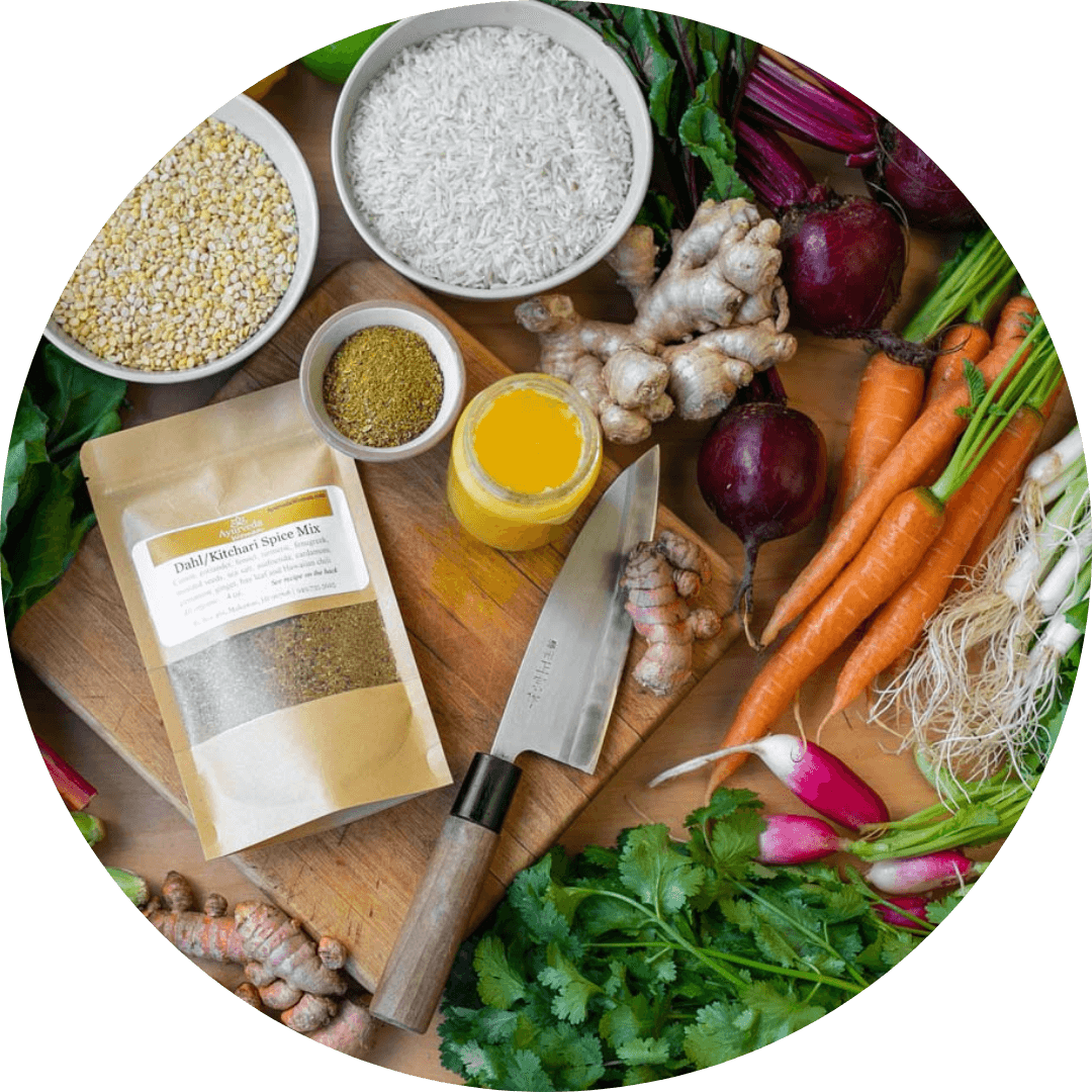 healthy food ingedrients arrnaged with a bag of dahl spice mix, knife and cutting board